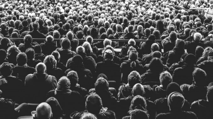 black-and-white-image-of-people-watching-football-match